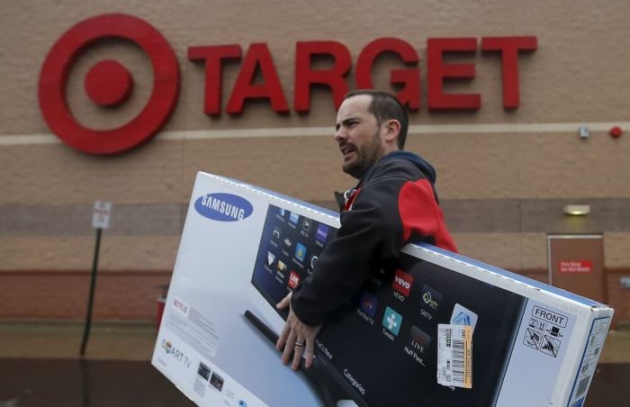 Ben Dobson carries his purchase of a television during Black Friday Shopping at a Target store in Chicago, Illinois, United States, November 27, 2015.