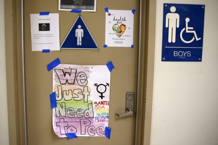 A protest sign on a bathroom which helped lobby for the first gender-neutral restroom in the Los Angeles school district is seen at Santee Education Complex high school in Los Angeles, California, U.S., April 18, 2016.