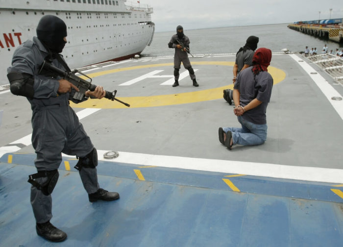 Members of an elite force of the Philippine Coast Guard hold mock terrorists at gunpoint on a ship during an anti-terrorism drill at the Coast Guard headquarters in Manila Bay, Manila, September 20, 2007.