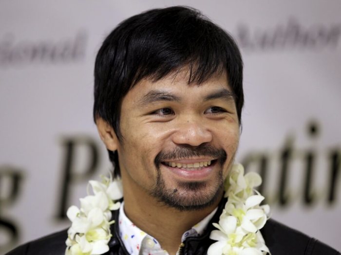 Filipino boxing champion Manny Pacquiao smiles during a brief conference upon his arrival at the Ninoy Aquino International Airport in Manila, Philippines, April 14, 2016.