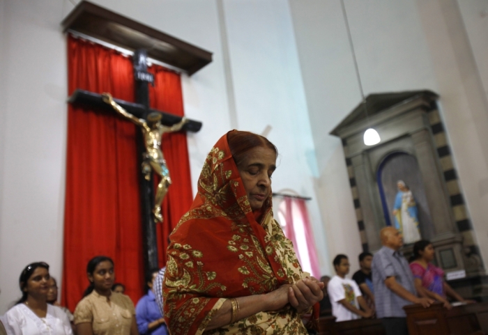 A woman attends a mass inside a church on Easter Day in New Delhi March 31, 2013. Holy Week is celebrated in many Christian traditions during the week before Easter.