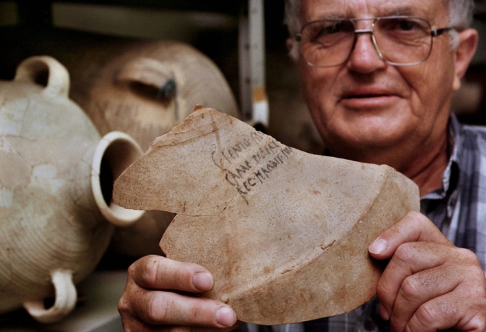 Israeli archaeologist Prof. Ehud Netzer displays the shard from a 2,000-year-old amphora bearing the name of 'Herod the Great, King of Judea' July 9. The unique ceramic shard, found during a recent archaeological dig on the ancient desert fortress of Masada, came from a large amphora used for shipping Italian wine to the king who ruled the holy land at the time of Jesus' birth.