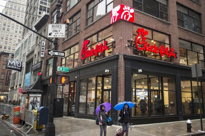 Commuters walk past a Chick-fil-A freestanding franchise in Midtown, New York, October 3, 2015.