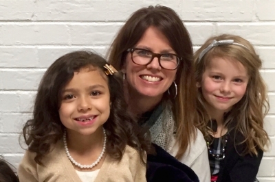 Kelsey Bohlender, pictured with two of her daughters, has an active life raising ten children