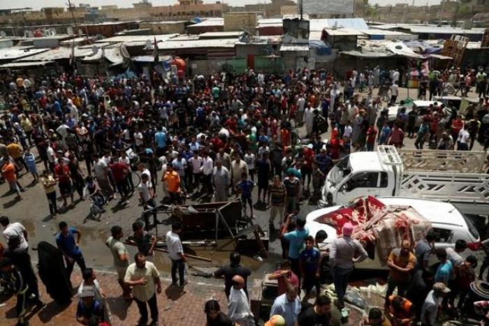 People gather at the scene of a car bomb attack in Baghdad's mainly Shi'ite district of Sadr City, Iraq, May 11, 2016.