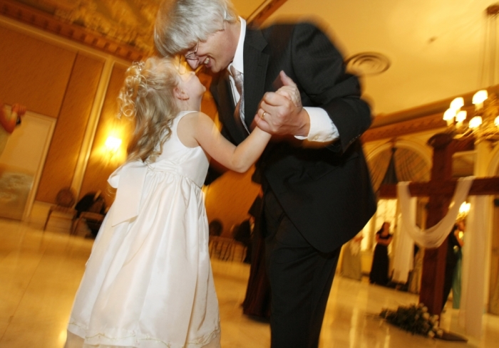 Dave Lorrig and his daughter Sarah Rose, 6, dance in front of a cross at the annual Father-Daughter Purity Ball in Colorado Springs, Colorado September 14, 2007. Picture taken September 14, 2007.