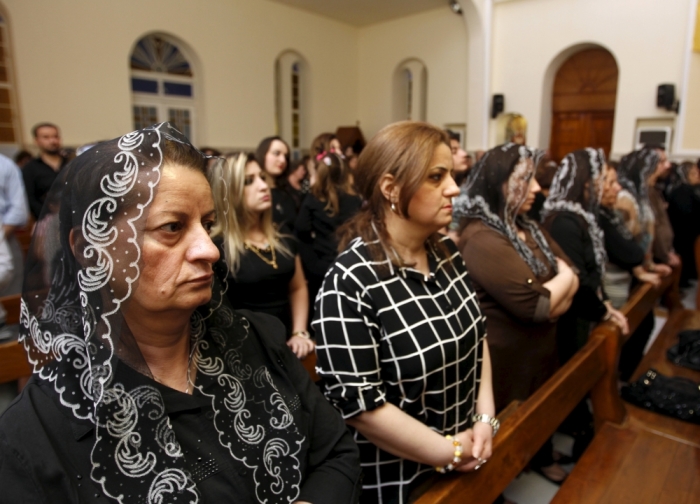 Iraqi Christians pray as they attend a Good Friday mass at a church in Baghdad, Iraq, March 25, 2016.