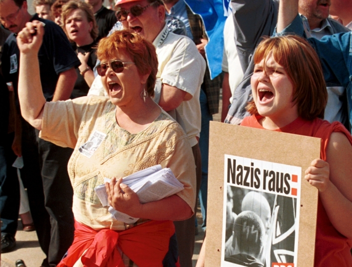 Citizen of Malchin shouts slogans and carry a poster reading 'Get Nazis out' in prtoest against supporters of the ultra right-wing German National Democratic Party (NPD) during their election campaign rally in the eastern German town of Malchin September 5. About a hundred people took part in the rally to campaign for the upcoming Mecklenburg-Vorpommern state elections and the German general elections in September.