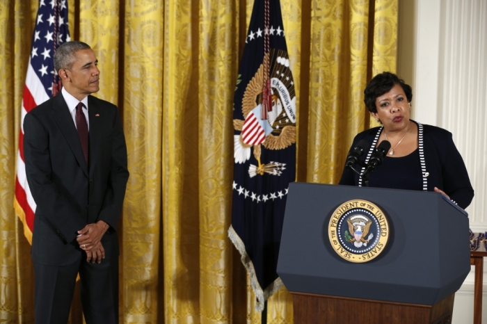 U.S. President Barack Obama (L) listens to Attorney General Loretta Lynch (R) before the awards ceremony for the Public Safety Officer Medal of Valor in the White House East Room in Washington, U.S., May 16, 2016.