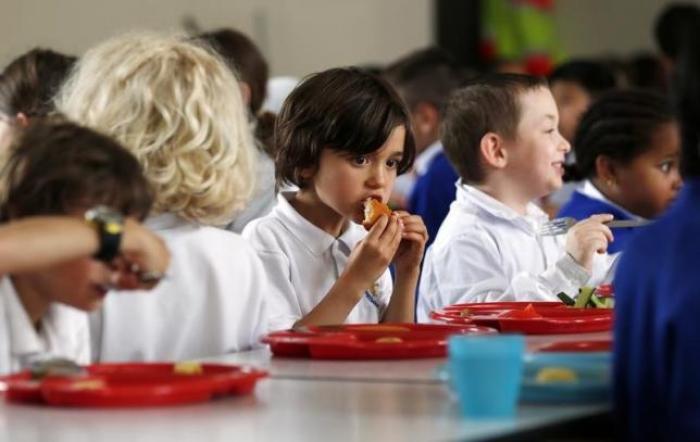 Students eat lunch at Salusbury Primary School in northwest London June 11, 2014.