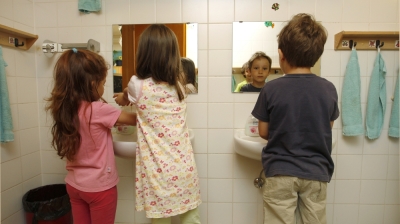 Children wash their hands in a bathroom at a nursery in Eichenau, near Munich, June 18, 2012.