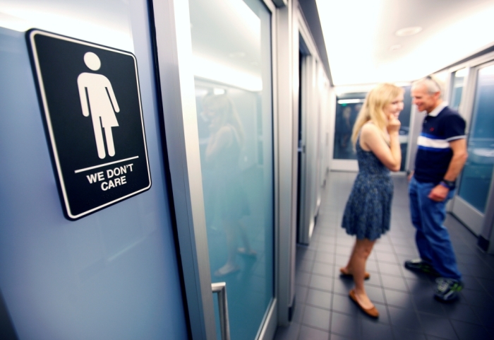A sign protesting a recent North Carolina law restricting transgender bathroom access adorns the bathroom stalls at the 21C Museum Hotel in Durham, North Carolina May 3, 2016. The hotel installed the restroom signage designed by artist Peregrine Honig last month after North Carolina's 'bathroom law' gained national attention, positioning the state at the center of a debate over equality, privacy and religious freedom.