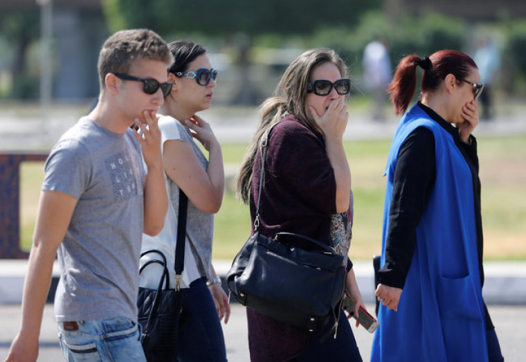 Unidentified relatives and friends of passengers who were flying in an EgyptAir plane that vanished from radar en route from Paris to Cairo react as they wait outside the Egyptair in-flight service building where relatives are being held at Cairo International Airport, Egypt May 19, 2016.