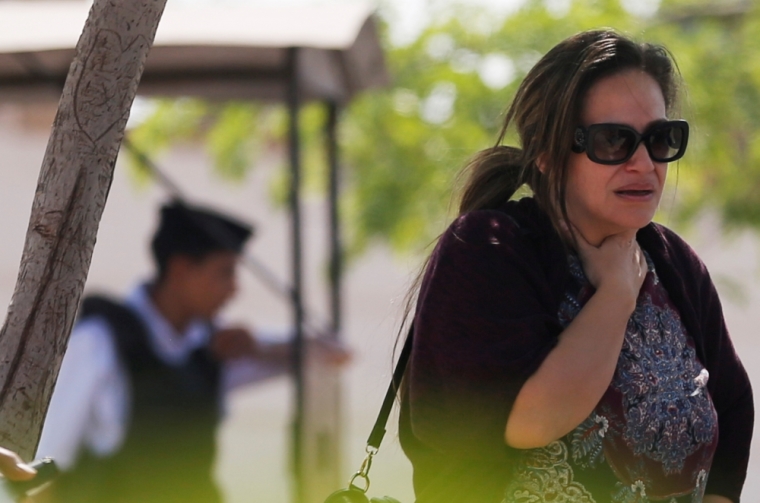 An unidentified woman reacts as she waits outside the EgyptAir in-flight service building, where relatives and friends of passengers who were flying in an EgyptAir plane that vanished from radar en route from Paris to Cairo are being held, at Cairo International Airport, Egypt May 19, 2016.