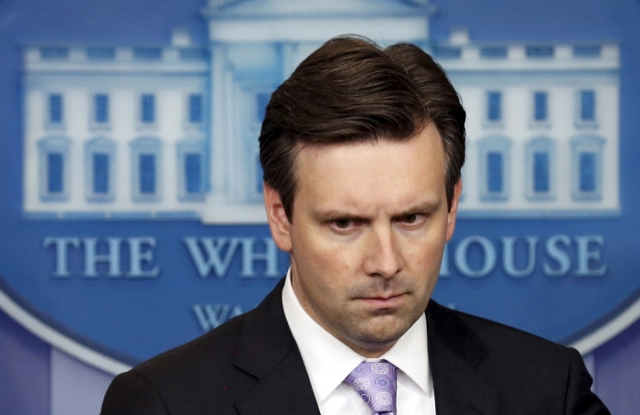 White House Press Secretary Josh Earnest arrives to deliver the daily media briefing to reporters at the White House in Washington July 8, 2015.