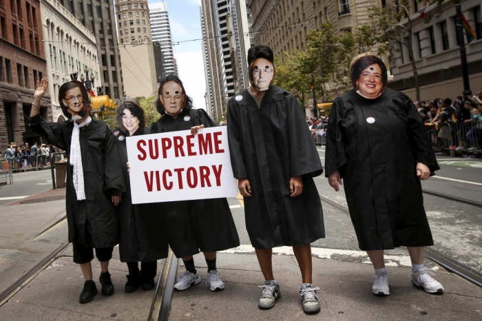 People dressed as the five U.S. Supreme Court justices who voted in favor of same-sex marriage, march in the San Francisco gay pride parade, two days after the Supreme Court's landmark decision that legalized same-sex marriage throughout the country in San Francisco, California June 28, 2015.