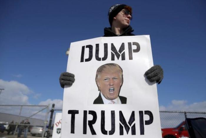 A protestor demonstrates outside a campaign rally for U.S. Republican presidential candidate Donald Trump in Cadillac, Michigan, March 4, 2016.