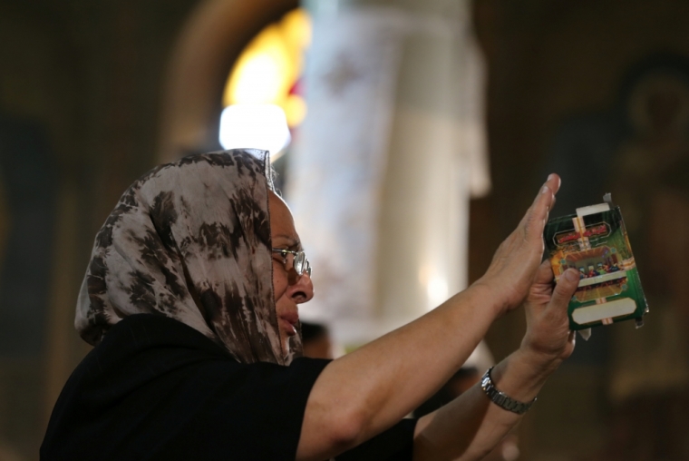 A relative of a Christian victim of the crashed EgyptAir flight MS804 reacts during an absentee funeral mass at the main Cathedral in Cairo, Egypt, May 22, 2016.
