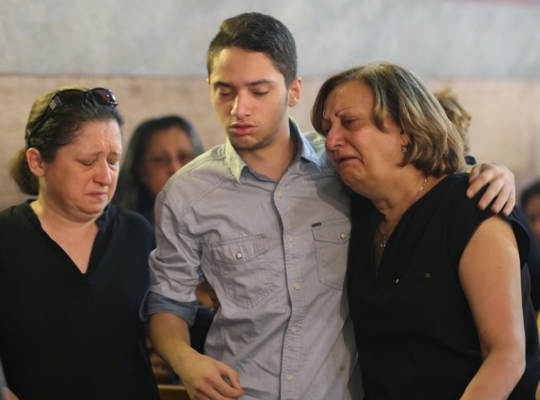 Relatives of the Christian victims of the crashed EgyptAir flight MS804 react during an absentee funeral mass at the main Cathedral in Cairo, Egypt, May 22, 2016.