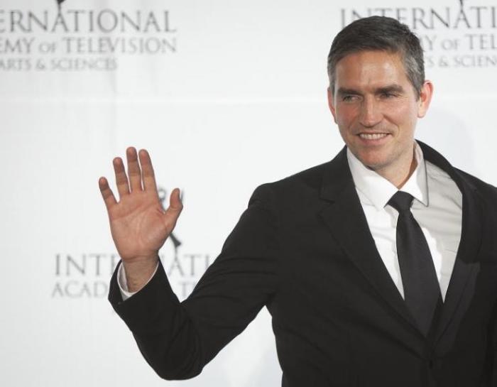 Actor Jim Caviezel poses for photographers backstage during the 41st International Emmy Awards in New York, November 25, 2013.