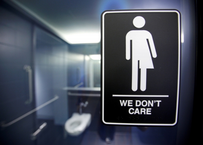 A sign protesting a recent North Carolina law restricting transgender bathroom access is seen in the bathroom stalls at the 21C Museum Hotel in Durham, North Carolina, May 3, 2016.