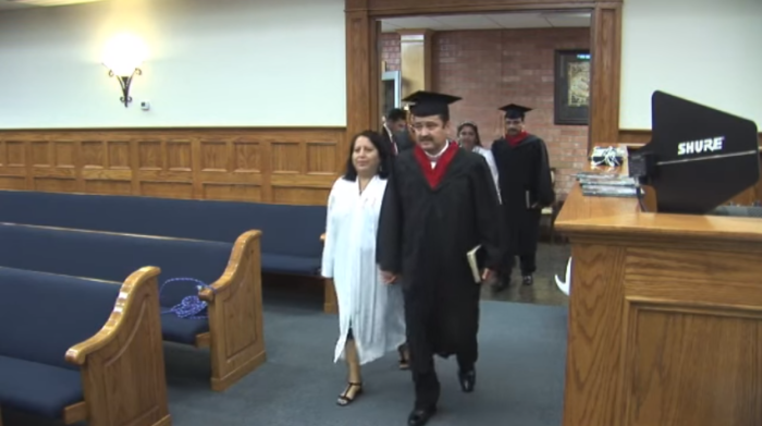 Pastor Israel Avelar, 46, and his wife Hilda 41, march as his graduation on Friday May 21, 2016.