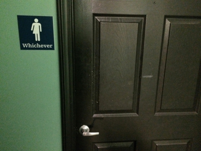 A bathroom sign welcomes both genders at a restaurant in Durham, North Carolina May 5, 2016. The restaurant installed the sign after North Carolina's 'bathroom law' gained national attention, positioning the state at the center of a debate over equality, privacy and religious freedom.