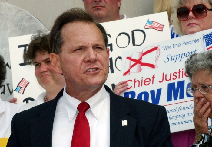 Alabama Chief Justice Roy Moore speaks outside the state Judicial building in Montgomery, August 25, 2003.