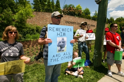 People attend a vigil outside the Cincinnati Zoo and Botanical Gardens, two days after a boy tumbled into its moat and officials were forced to kill Harambe, a Western lowland gorilla, in Cincinnati, Ohio, U.S. May 30, 2016.
