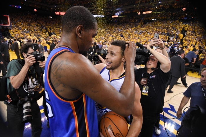 Golden State Warriors guard Stephen Curry (30, right) is congratulated by former Oklahoma City Thunder forward Kevin Durant (35) after game seven of the Western conference finals of the NBA Playoffs at Oracle Arena. The Warriors defeated the Thunder 96-88, Oakland, California, May 30, 2016.