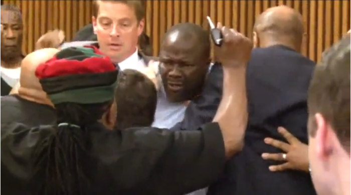 Van Terry, father of murder victim, Shirellda Terry, 18, is restrained after attacking serial killer Michael Madison for smiling at him in court on Thursday June 2, 2016.