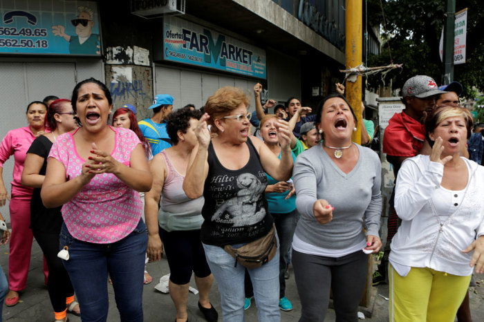 People shout at Venezuelan National Guards (not pictured) during riots for food in Caracas, Venezuela, June 2, 2016.