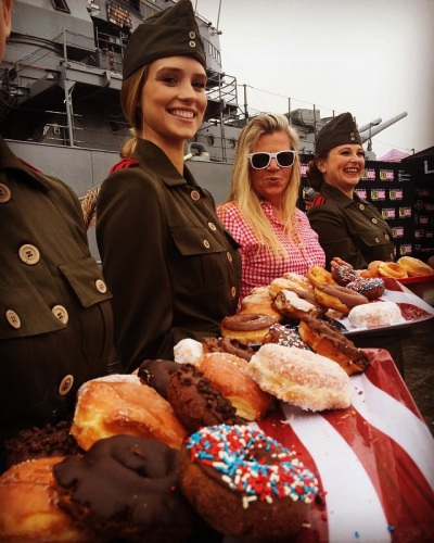 Volunteers get 'historic' as doughnut lassies during National Donut Day hosted by Salvation Army at site of USS Iowa in LA Harbor.