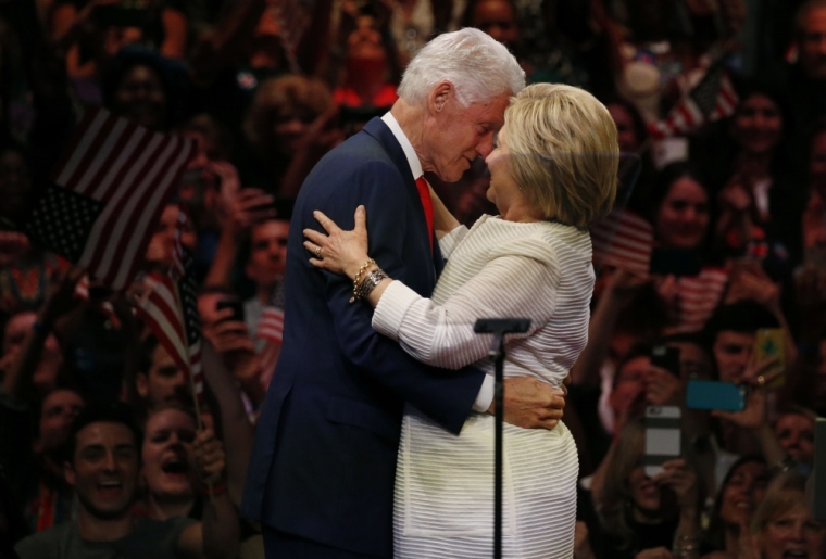 Democratic U.S. presidential candidate Hillary Clinton hugs her husband former President Bill Clinton while speaking during her California primary night rally held in the Brooklyn borough of New York, U.S., June 7, 2016.