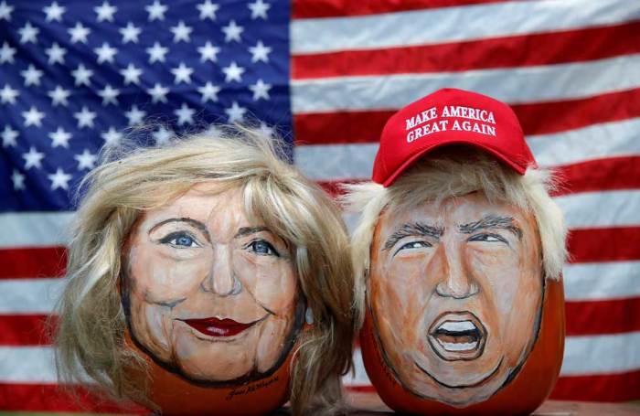 The images of U.S. Democratic presidential candidate Hillary Clinton (L) and Republican Presidential candidate Donald Trump are seen painted on decorative pumpkins created by artist John Kettman in LaSalle, Illinois, U.S., June 8, 2016.