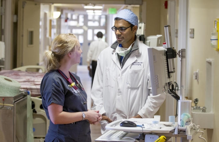 Dr. Paul Kalanithi, M.D., speaks with a fellow healthcare professional in this undated photo.