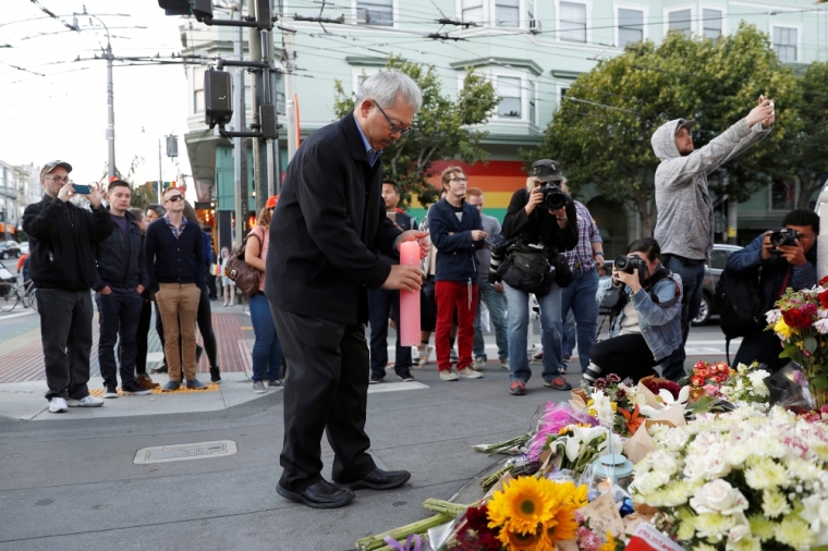San Francisco Mayor Ed Lee leaves a candle at a memorial for the victims of the Orlando shooting at a gay nightclub, held in San Francisco, California, U.S. June 12, 2016.