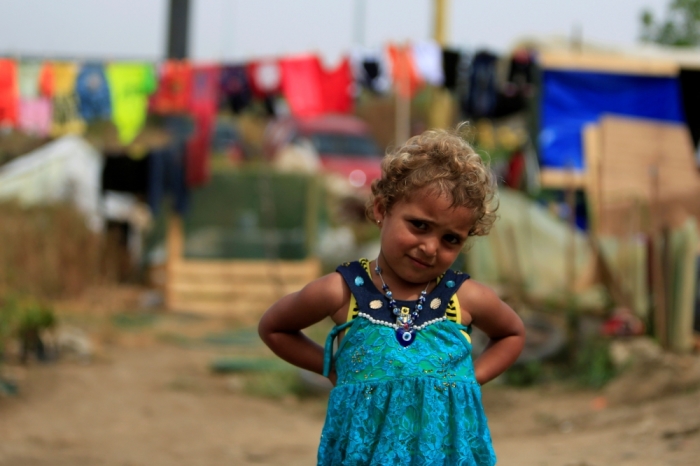 A Syrian refugee girl poses outside tents during the visit of Dutch Prime Minister Mark Rutte to the refugee camp in Zahrani village, southern Lebanon May 3, 2016.