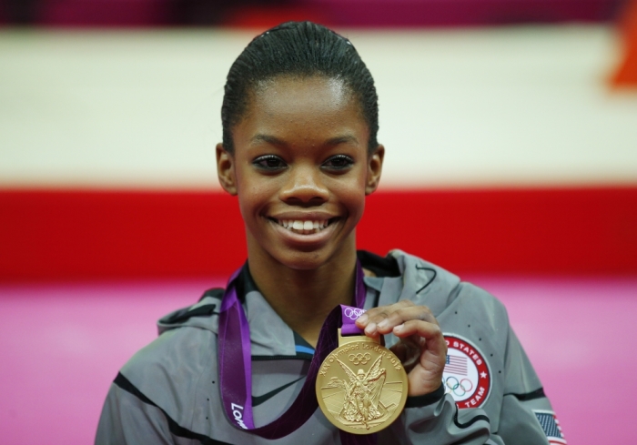 Gold medalist Gabrielle Douglas of the U.S. stands on the podium after the women's individual all-around gymnastics final in the North Greenwich Arena at the London 2012 Olympic Games in this August 2, 2012 file photograph. Watched by billions, the Olympics provide the ultimate stage for any athlete and each successive Games etches new names on the world's sporting consciousness.