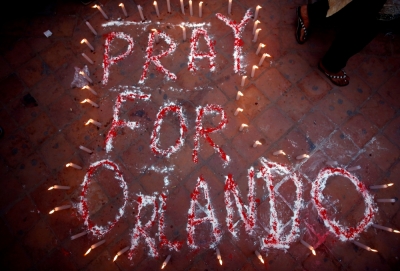 Candles are lit around a sign that reads 'Pray for Orlando' during a vigil in memory of the victims of the Pulse gay nightclub shooting in Orlando, Florida, in Kathmandu, Nepal, June 17, 2016.