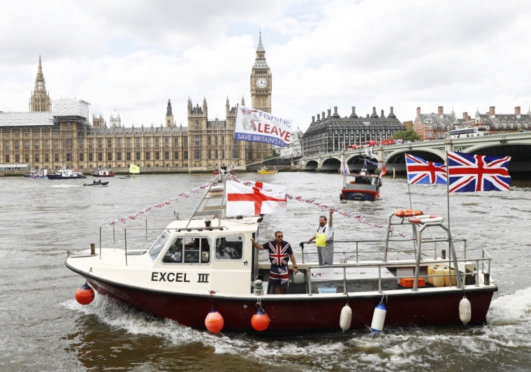 Part of a flotilla of fishing vessels campaigning to leave the European Union sails past Parliament on the river Thames in London, England, June 15, 2016.