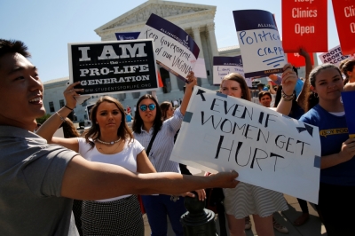 Pro-abortion protesters and pro-life advocates jostle with their signs as they demonstrate in the hopes of a ruling in their favor on decisions at the Supreme Court building in Washington, U.S. June 20, 2016.