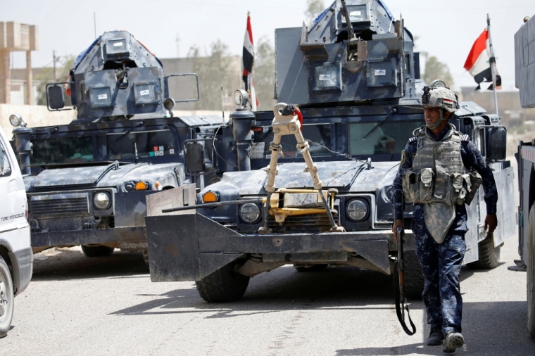 Military vehicles of Iraqi security forces are seen in Falluja, Iraq, June 25, 2016.