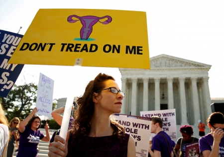 Demonstrators hold signs outside the U.S. Supreme Court as the court is due to issue its first major abortion ruling since 2007 in Washington, U.S. June 27, 2016.
