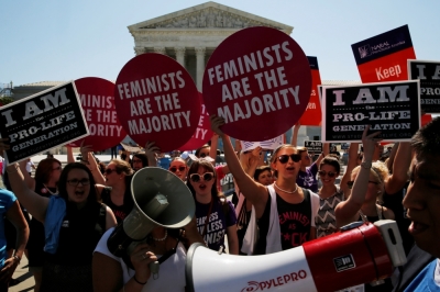 Pro-abortion protesters and pro-life activists jostle with their signs as they demonstrate in the hopes of a ruling in their favor on decisions at the Supreme Court building in Washington, U.S. June 20, 2016.