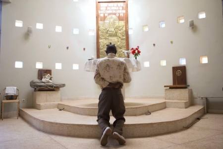 A man prays after mass at the Martyrs of Uganda church in Bamako, Mali, November 8, 2015.