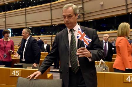 Nigel Farage, the leader of the United Kingdom Independence Party, holds the British flag as he attends a plenary session at the European Parliament on the outcome of the "Brexit" in Brussels, Belgium, June 28, 2016.