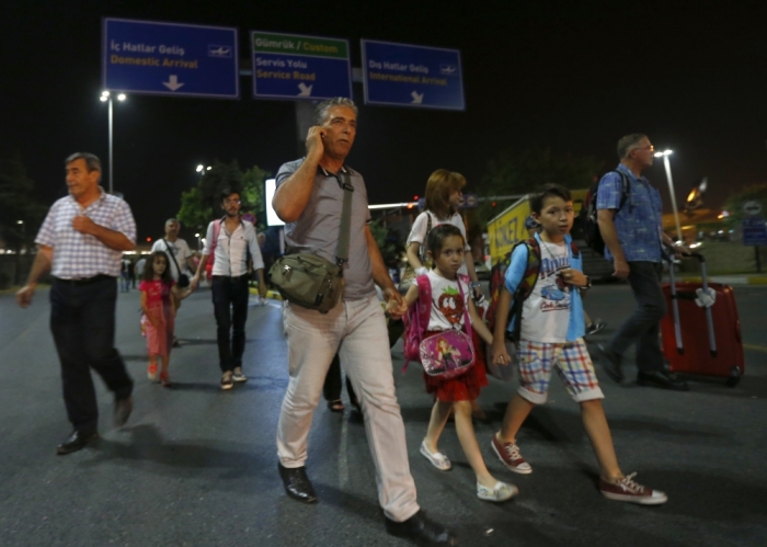 People leave Turkey's largest airport, Istanbul Ataturk, Turkey, following a blast June 28, 2016.