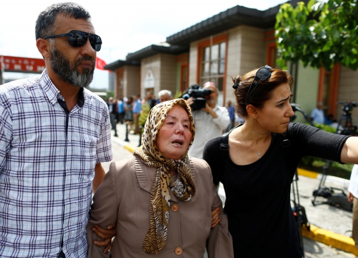 Sacide Bugda, mother of Abdulhekim Bugda who was one of the victims of yesterday's blast at Istanbul Ataturk Airport, is comforted by her relatives as she walks to the front of a morgue in Istanbul, Turkey, June 29, 2016.