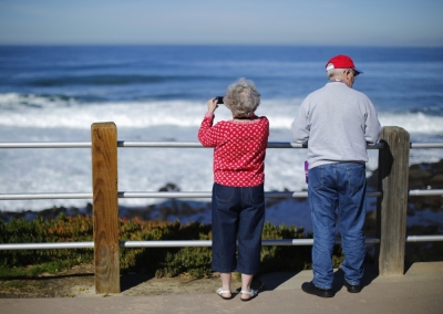 A retired couple take in the ocean during a visit to the beach in La Jolla, California.